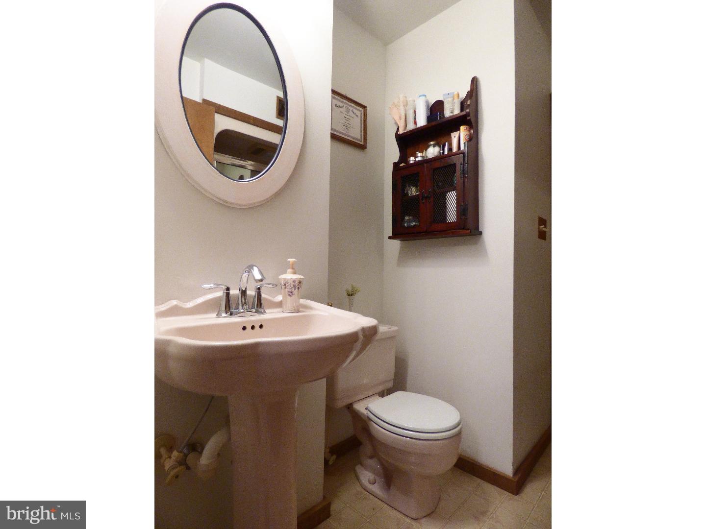 124 Alloway-Woodstown Road Alloway, NJ 08098 - Photo 22 of 25 a bathroom with a sink and a mirror