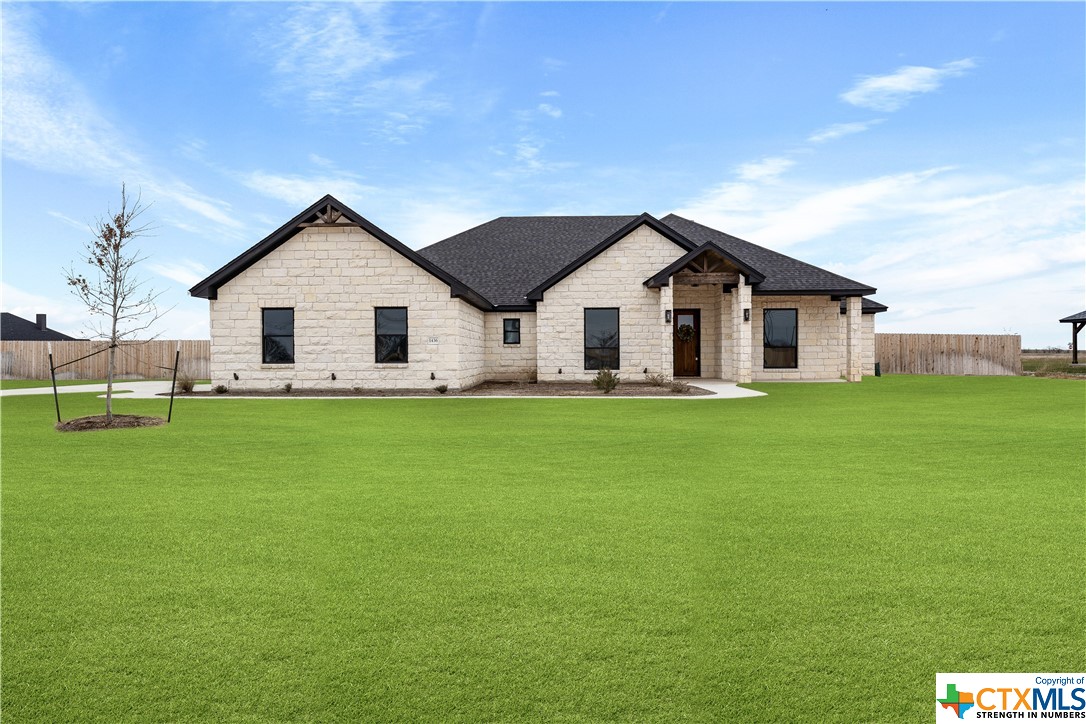 a front view of house with a garden
