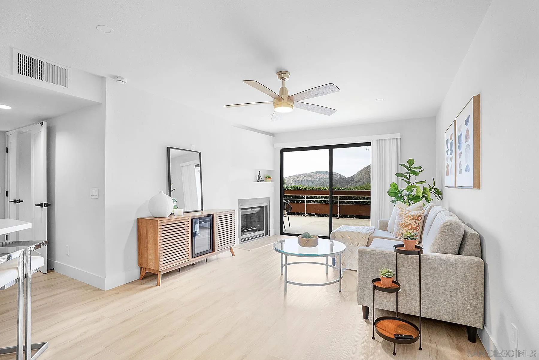 7227 Navajo Road, Unit 103 San Diego, CA 92119 - Photo 5 of 29 a living room with furniture a flat screen tv and a large window