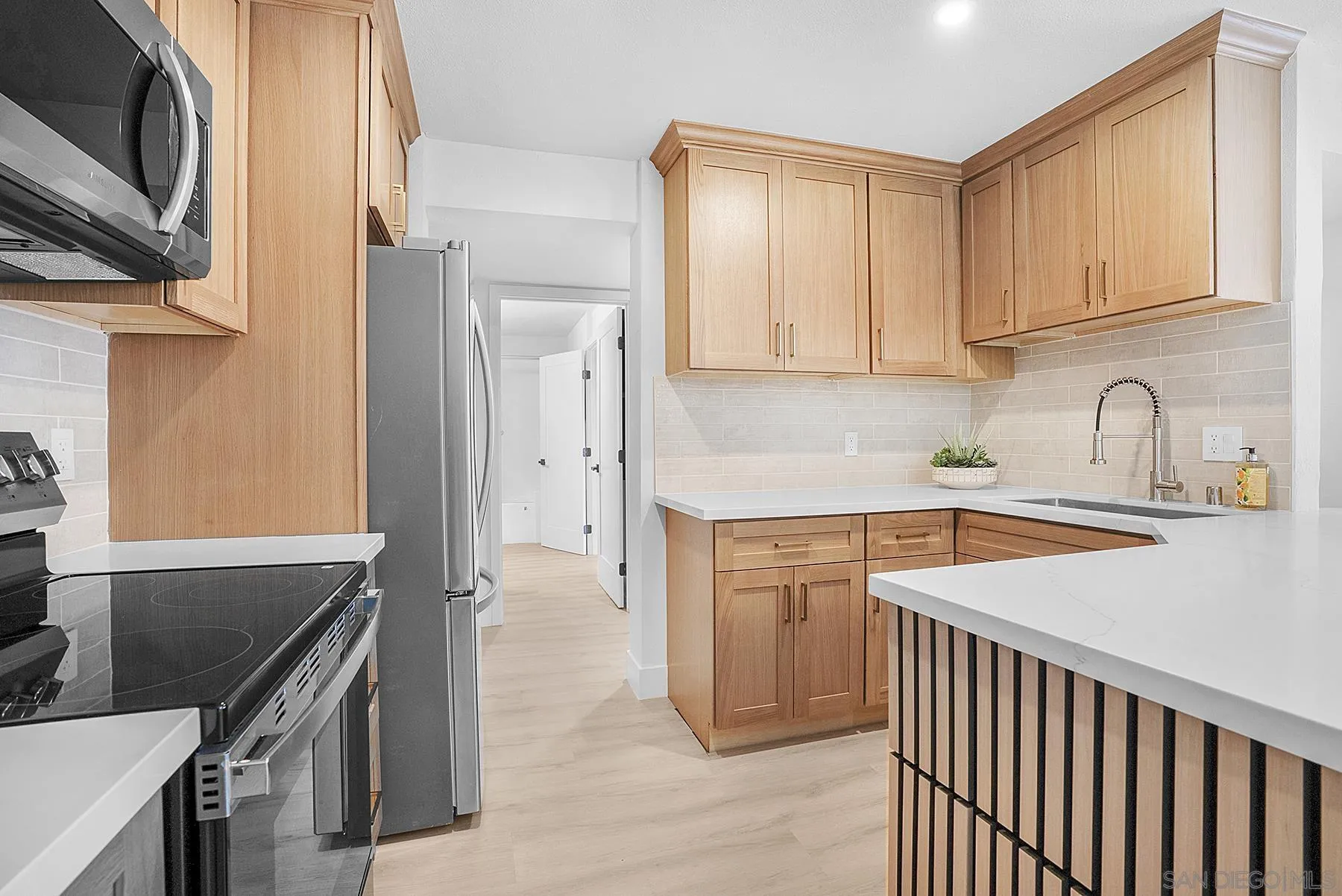7227 Navajo Road, Unit 103 San Diego, CA 92119 - Photo 7 of 29 a kitchen with stainless steel appliances granite countertop a sink stove and refrigerator