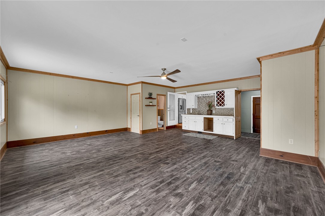 433 Latham Road Easley, SC 29640 - Photo 23 of 50 An open-concept area featuring modern flooring and a built-in wet bar, ideal for entertaining.