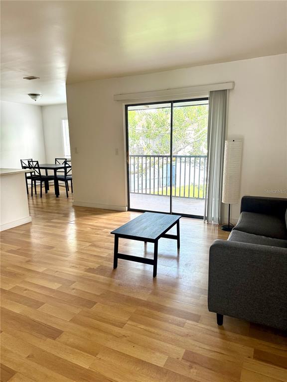 13300 Walsingham Road, Unit 11 Largo, FL 33774 - Photo 2 of 19 a living room with furniture and a large window