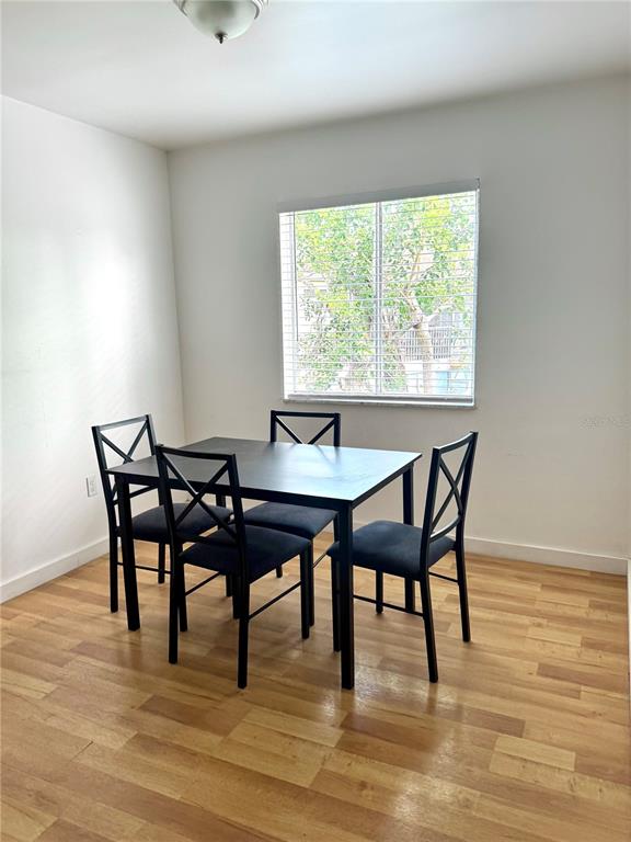 13300 Walsingham Road, Unit 11 Largo, FL 33774 - Photo 4 of 19 a view of a dining room with furniture and wooden floor