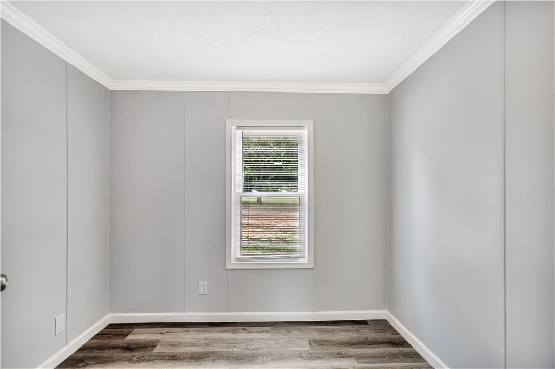 403 Hancox Place Westminster, SC 29693 - Photo 29 of 39 A well-proportioned room showcases fresh plank flooring and a single window overlooking green surroundings.