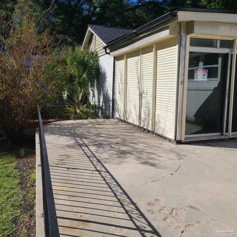 a view of a house with pool and a yard