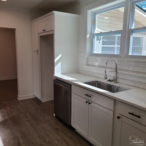 a kitchen with a sink and cabinets
