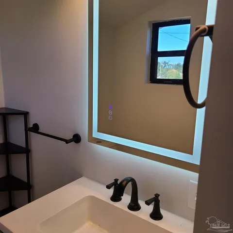 a bathroom with a sink and a mirror