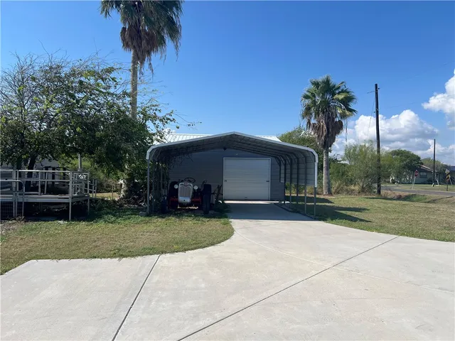 a view of a house with garden and a yard