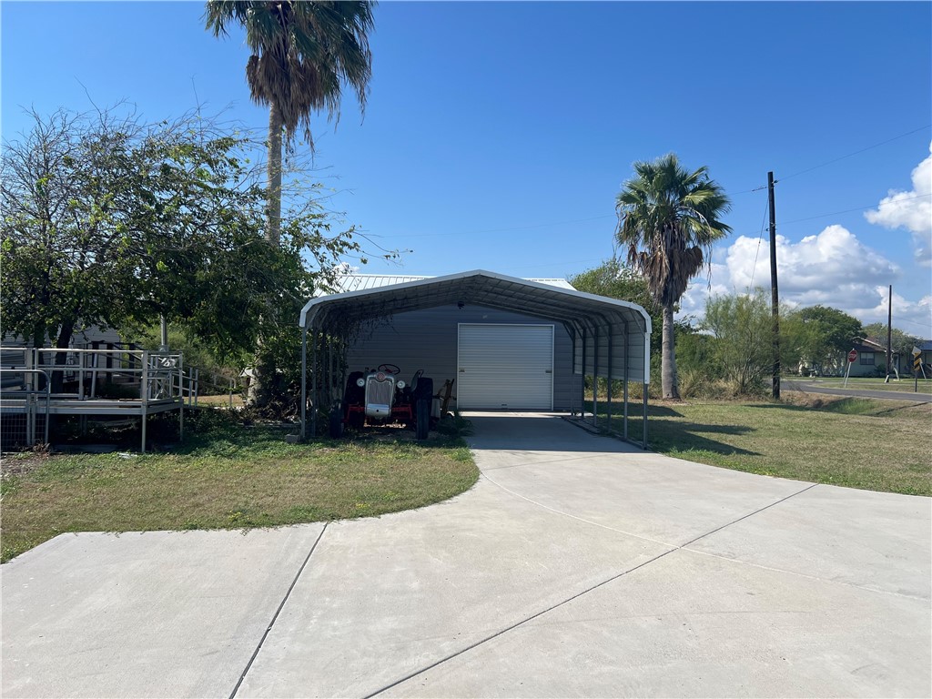 a view of a house with garden and a yard