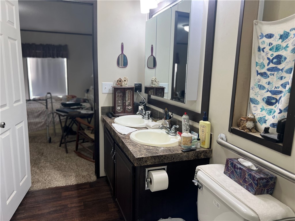802 1st Street Bayside, TX 78340 - Photo 19 of 22 a bathroom with a sink and a mirror with toilet
