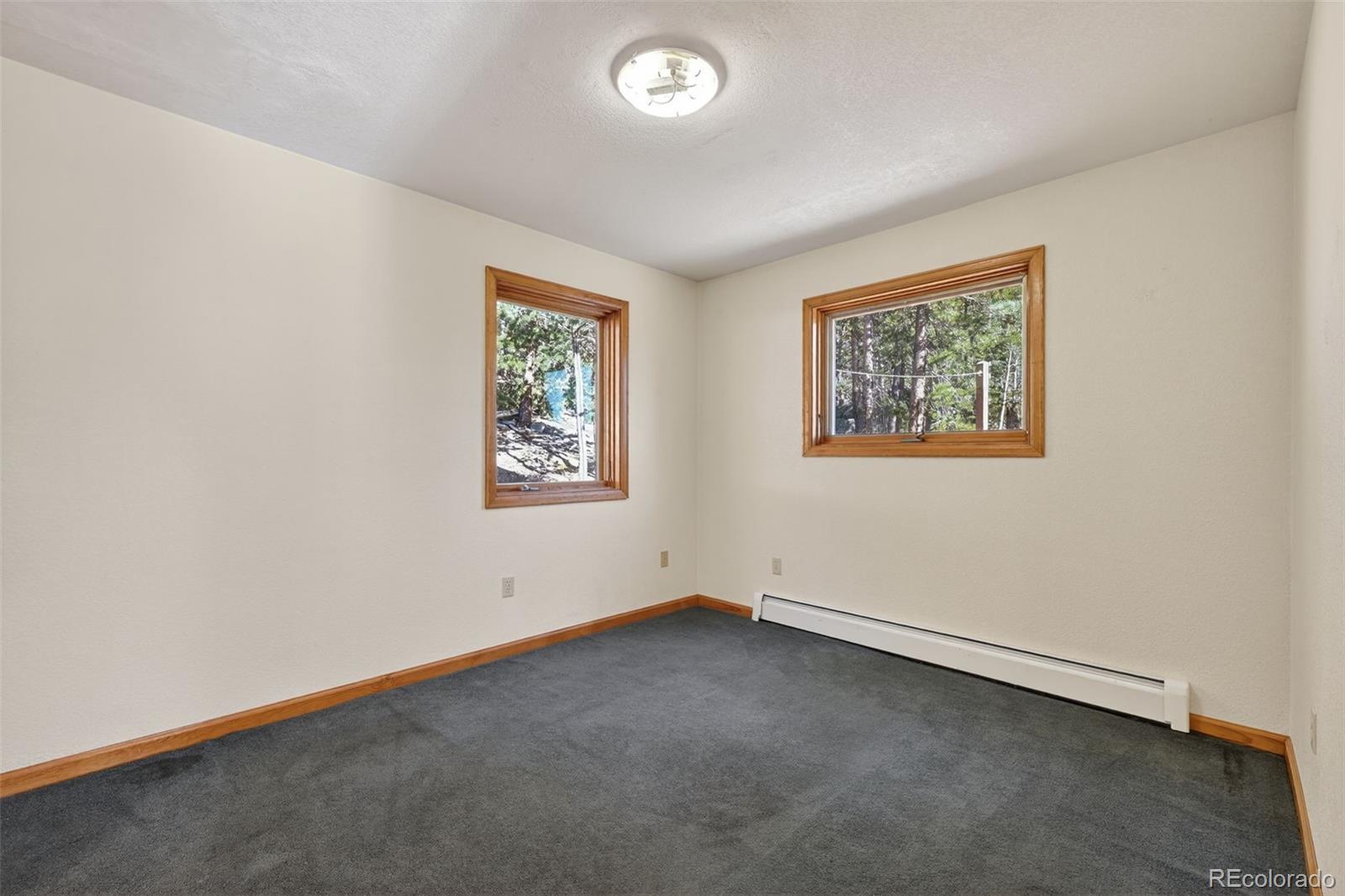 3581 Gap Road Golden, CO 80403 - Photo 13 of 45 an empty room with windows
