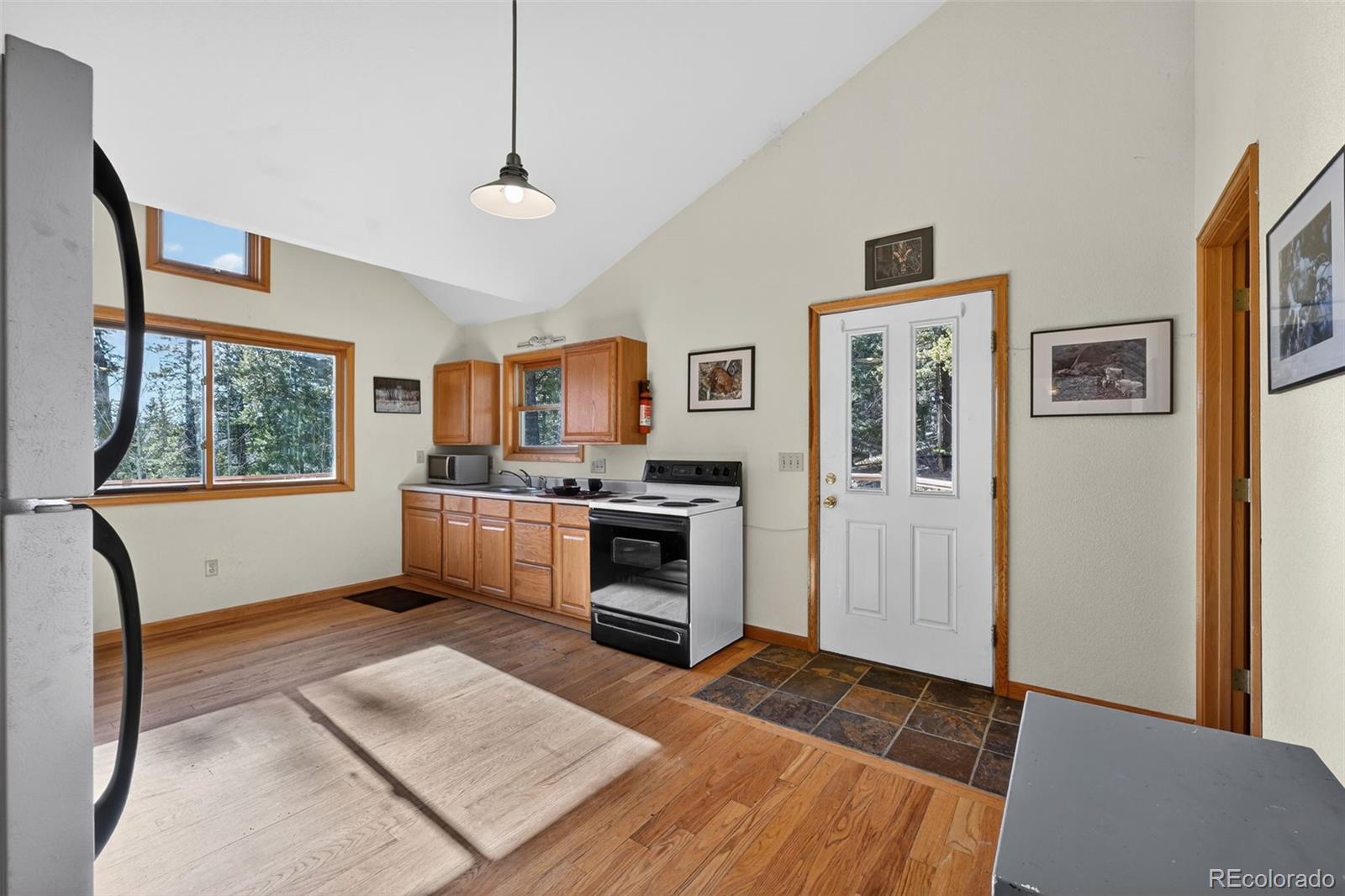 3581 Gap Road Golden, CO 80403 - Photo 17 of 45 a kitchen with granite countertop a refrigerator and a stove top oven