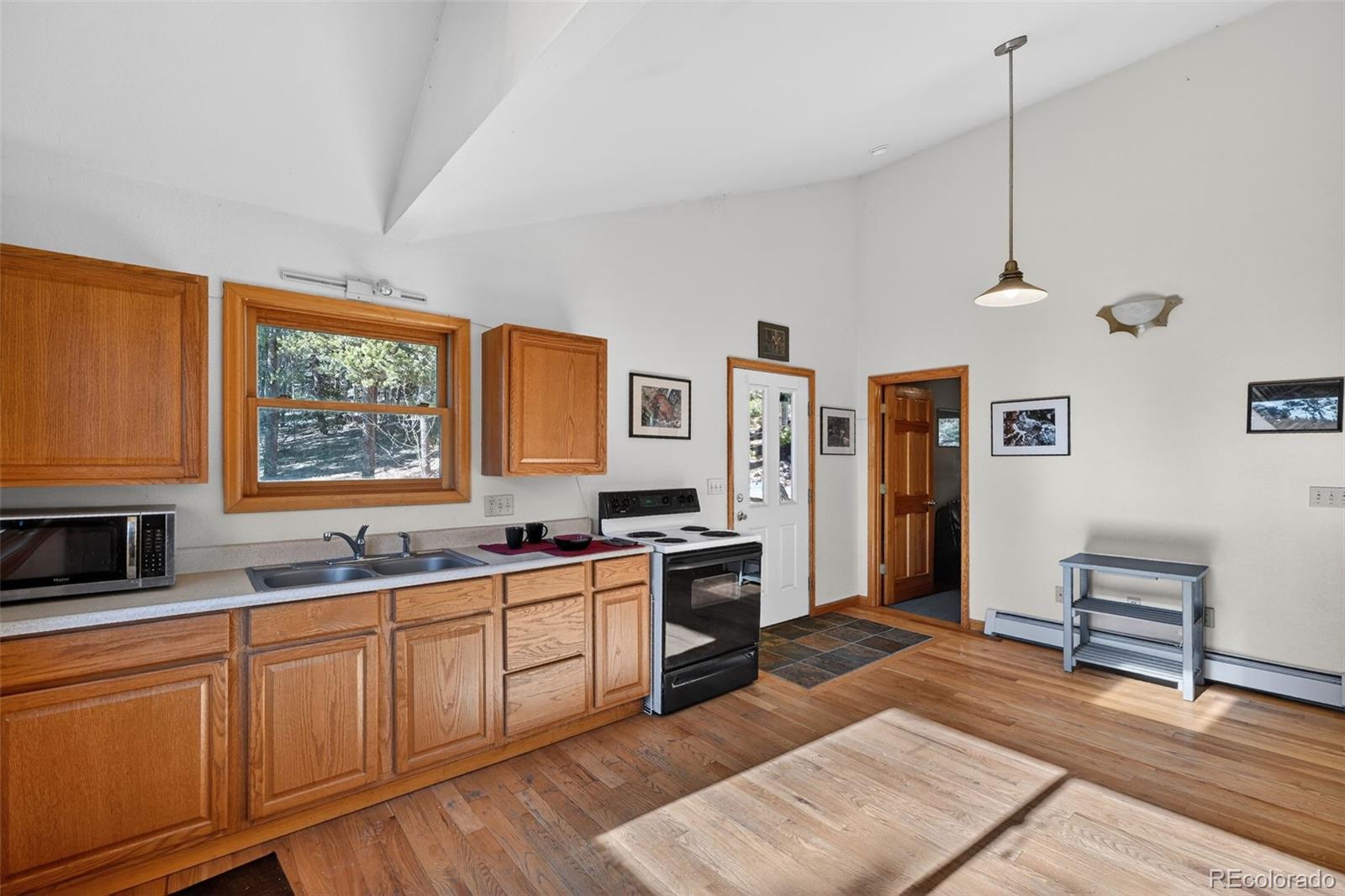 3581 Gap Road Golden, CO 80403 - Photo 18 of 45 a kitchen with stainless steel appliances granite countertop a stove a sink dishwasher and a refrigerator with wooden floor