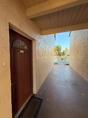 a view of a porch with furniture and a gate