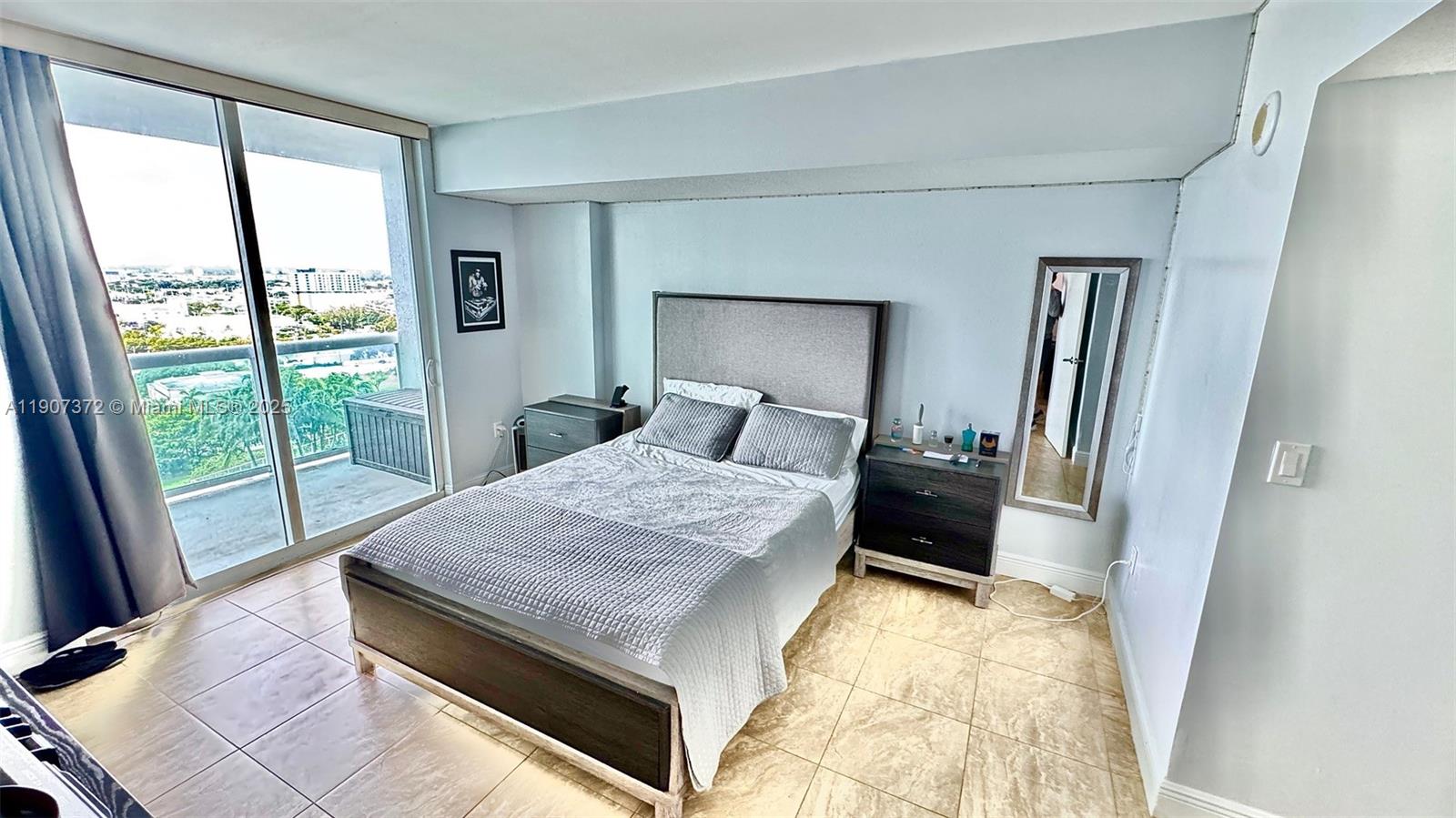 1800 North Bayshore Drive, Unit 1906 Miami, FL 33132 - Photo 16 of 21 a room with a bed and a large window