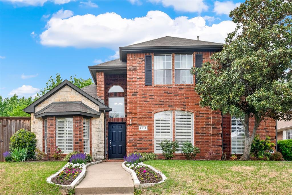 2813 Ashbury Drive Richardson, TX 75082 - Photo 1 of 1 a front view of a house with garden