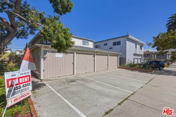 a view of a house with wooden deck front of house