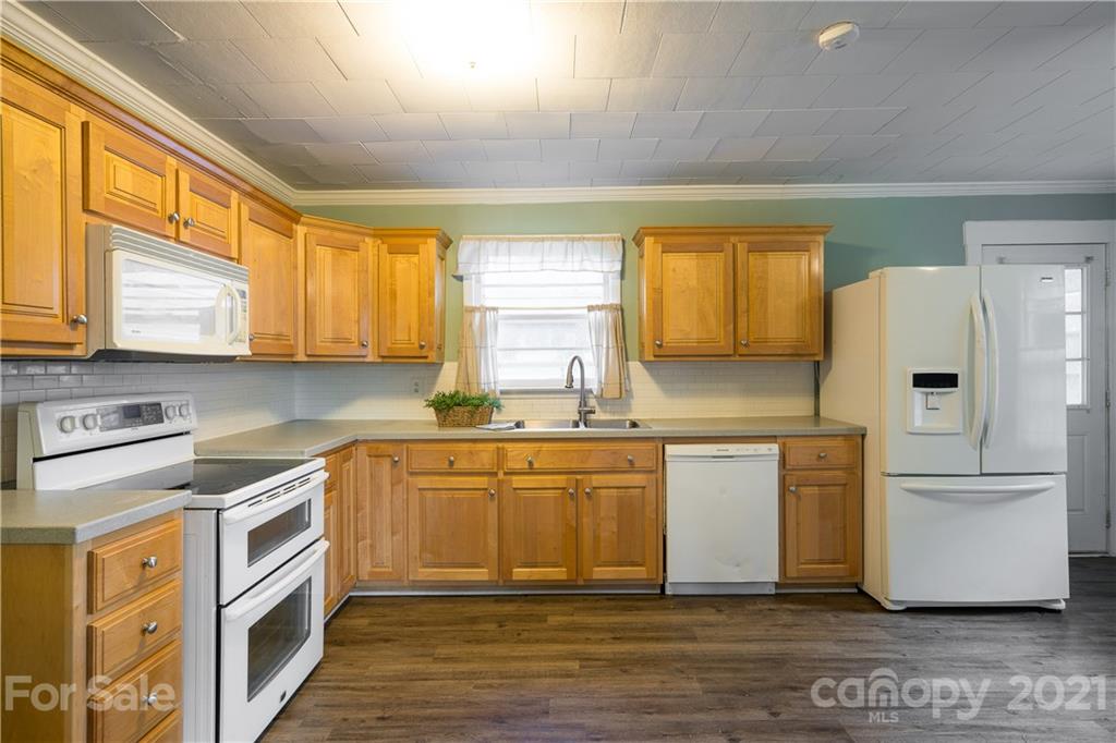 2289 Claremont Road Newton, NC 28658 - Photo 12 of 20 a kitchen with stainless steel appliances granite countertop a refrigerator a stove a sink and a microwave