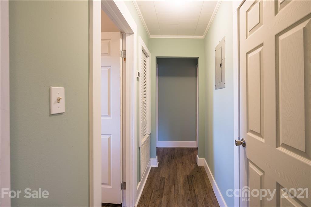 2289 Claremont Road Newton, NC 28658 - Photo 14 of 20 a view of a hallway with wooden floor and a bathroom