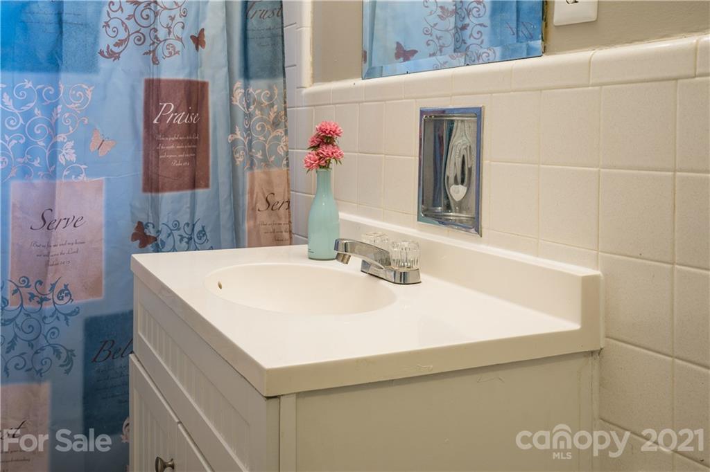 2289 Claremont Road Newton, NC 28658 - Photo 16 of 20 a bathroom with a sink and a mirror
