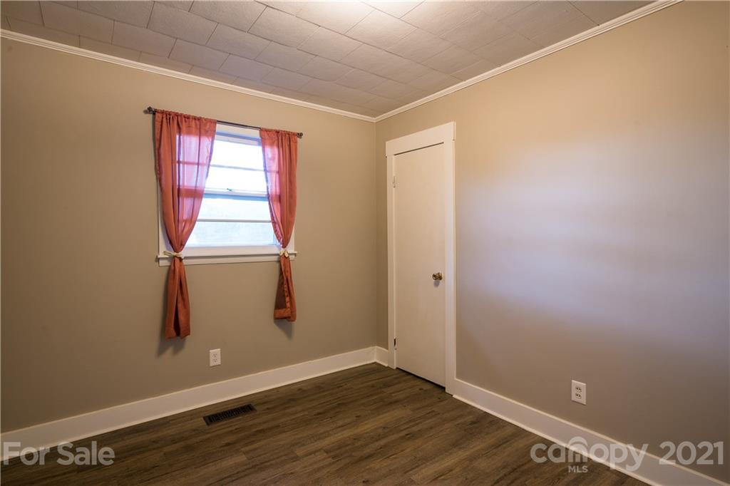 2289 Claremont Road Newton, NC 28658 - Photo 17 of 20 an empty room with wooden floor and windows