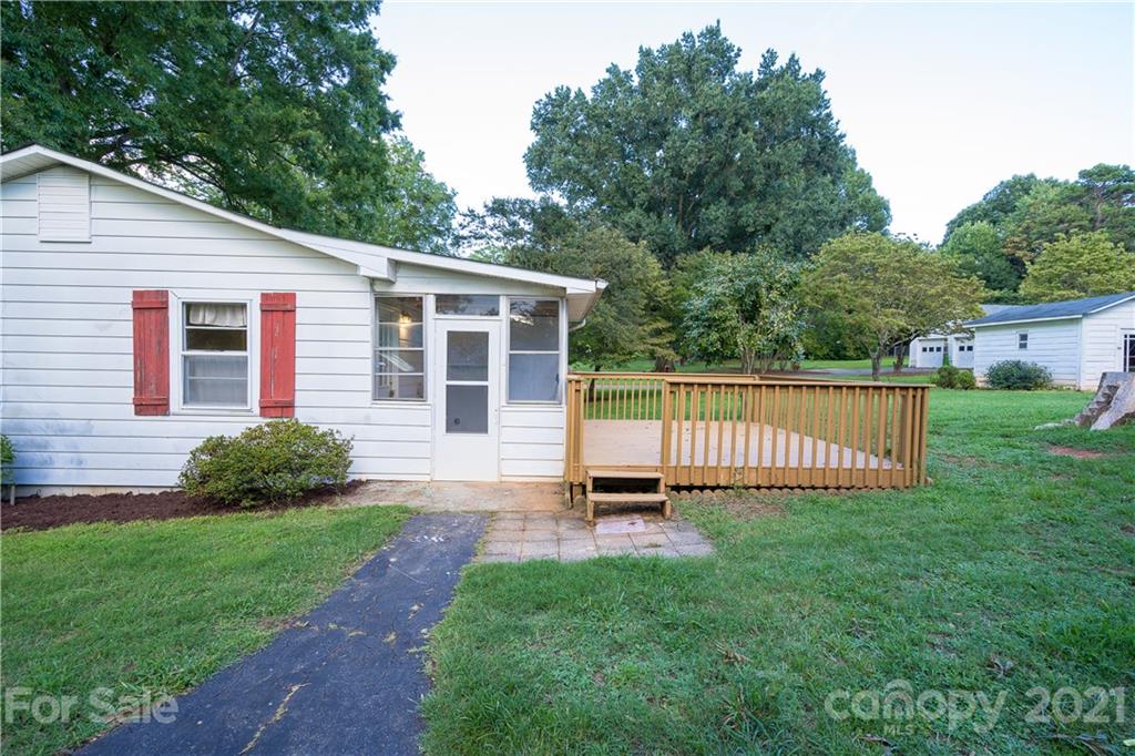 2289 Claremont Road Newton, NC 28658 - Photo 3 of 20 a view of a house with a backyard and a garden