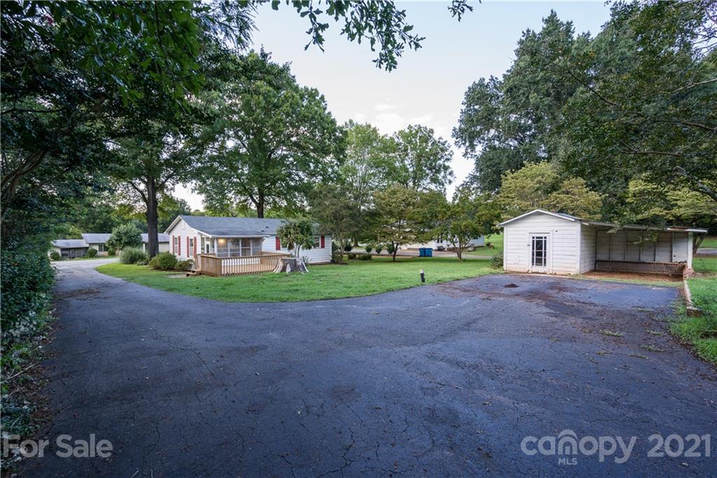 2289 Claremont Road Newton, NC 28658 - Photo 5 of 20 a front view of a house with a garden and trees
