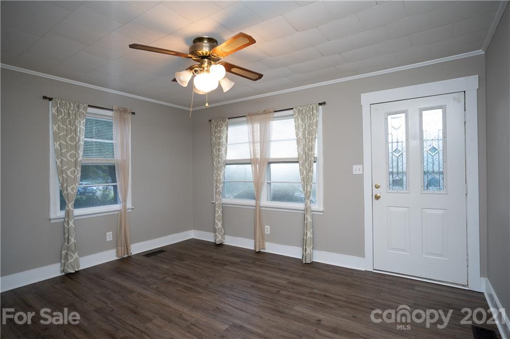 2289 Claremont Road Newton, NC 28658 - Photo 10 of 20 an empty room with wooden floor fan and windows