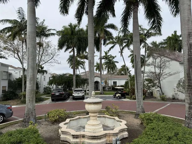 a swimming pool with outdoor seating and a garden