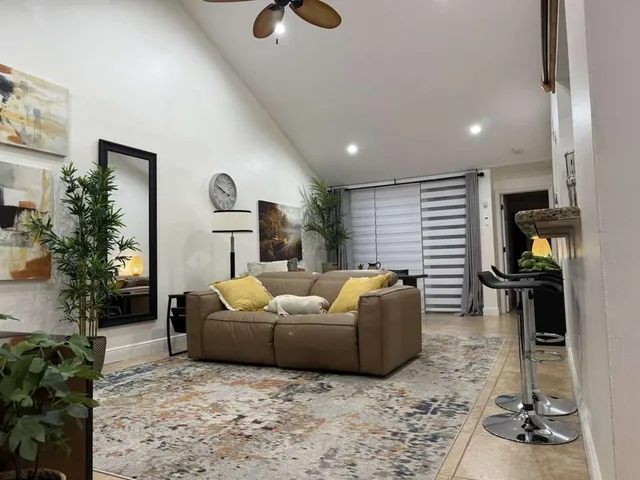 a living room with furniture and a potted plant