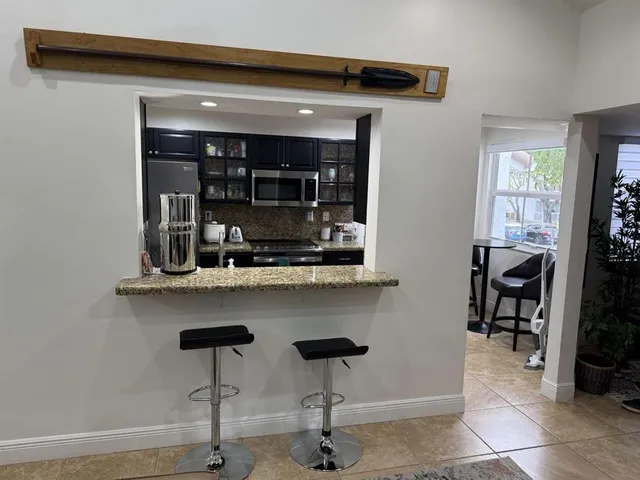 a kitchen with a sink cabinets and window