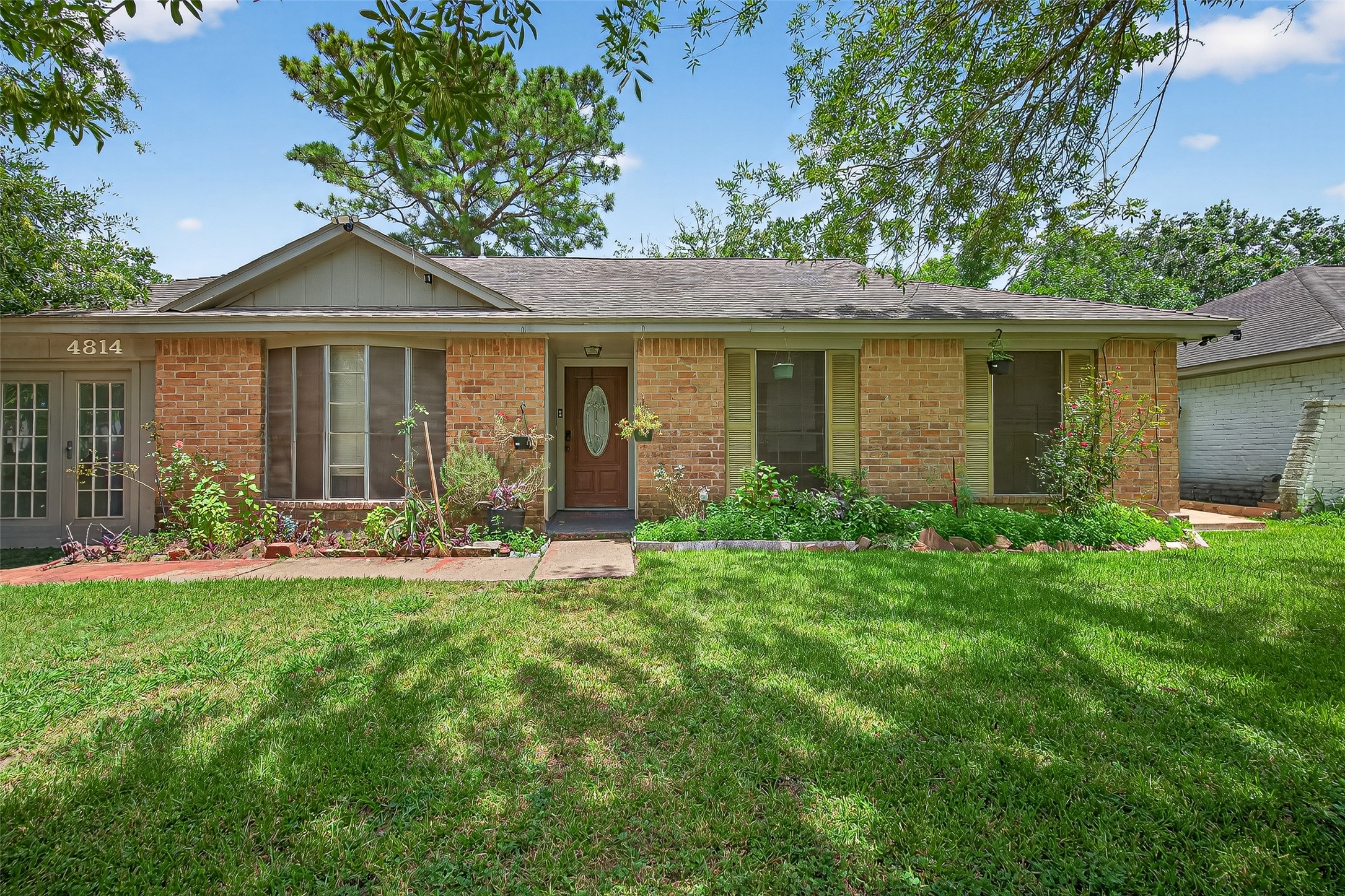 a front view of house with yard and green space
