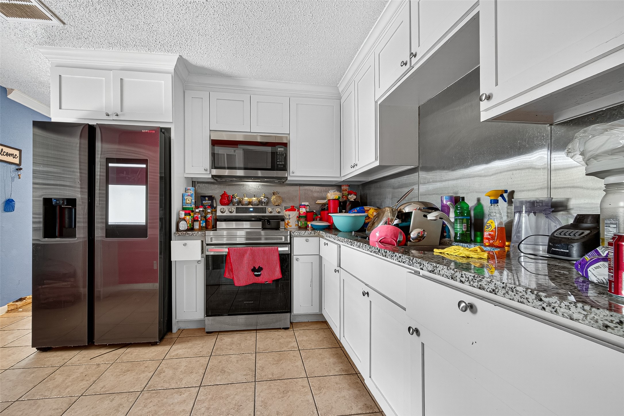 4814 Ridgestone Street Houston, TX 77053 - Photo 2 of 29 a kitchen with a refrigerator and a sink