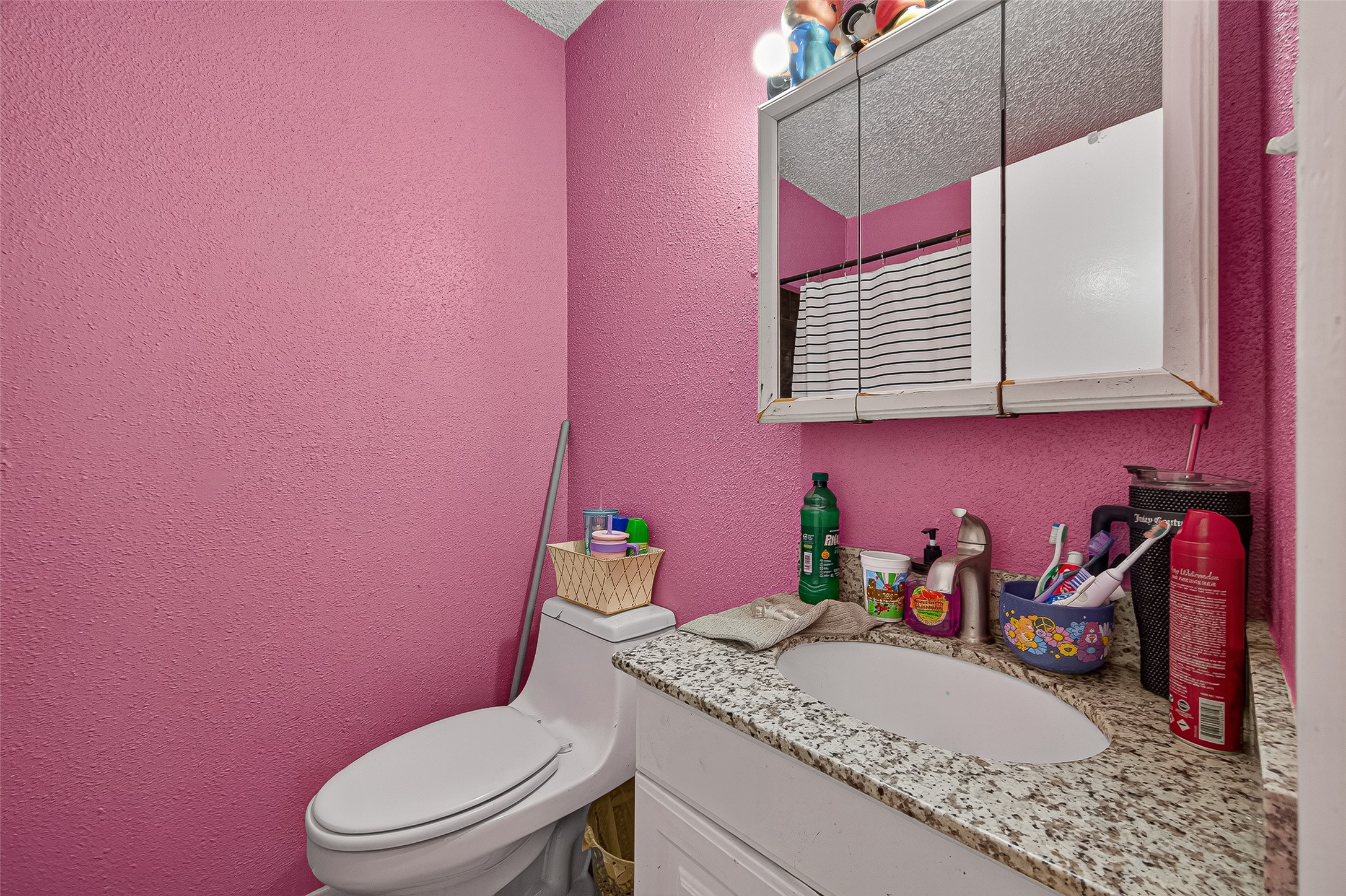 4814 Ridgestone Street Houston, TX 77053 - Photo 22 of 29 a bathroom with a granite countertop sink mirror vanity and toilet