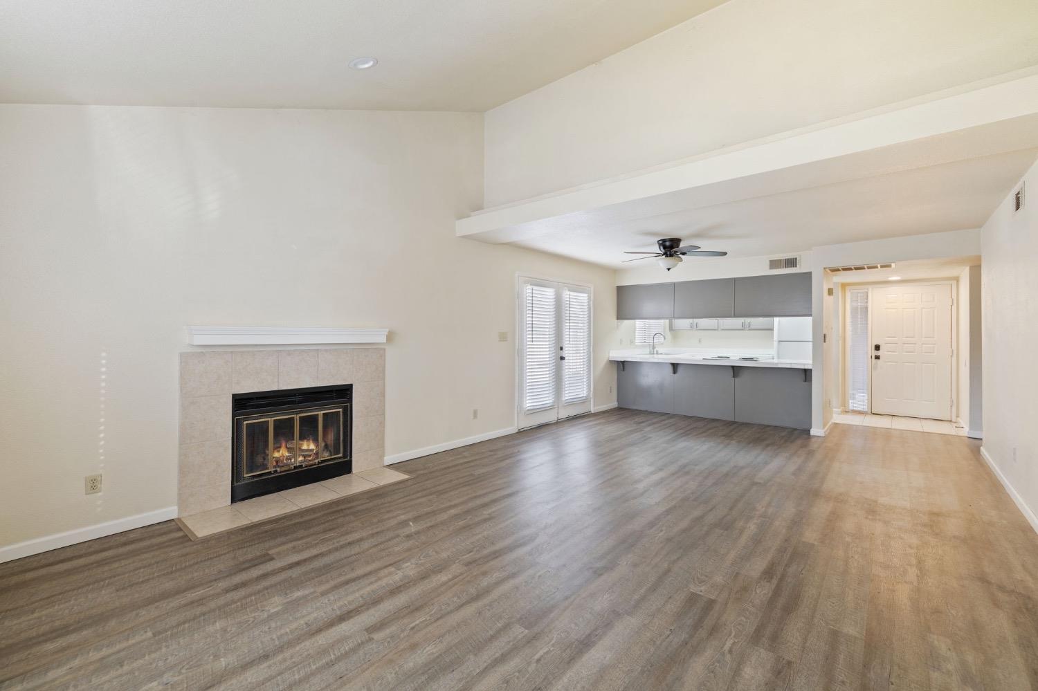 7675 North First Street, Unit 136 Fresno, CA 93720 - Photo 13 of 42 an empty room with wooden floor and fireplace