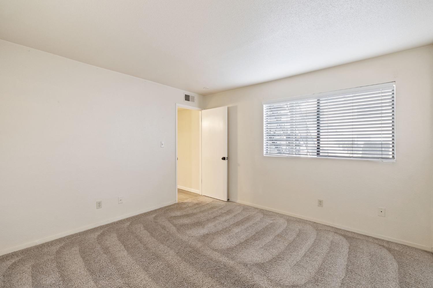 7675 North First Street, Unit 136 Fresno, CA 93720 - Photo 16 of 42 a view of an empty room with a window