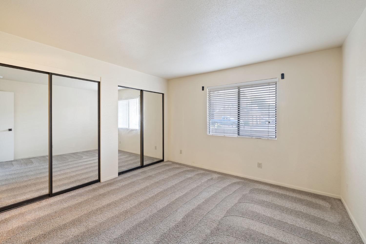 7675 North First Street, Unit 136 Fresno, CA 93720 - Photo 19 of 42 an empty room with windows