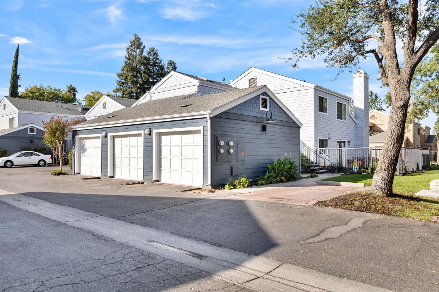 7675 North First Street, Unit 136 Fresno, CA 93720 - Photo 38 of 42 a front view of a house with a yard and potted plants