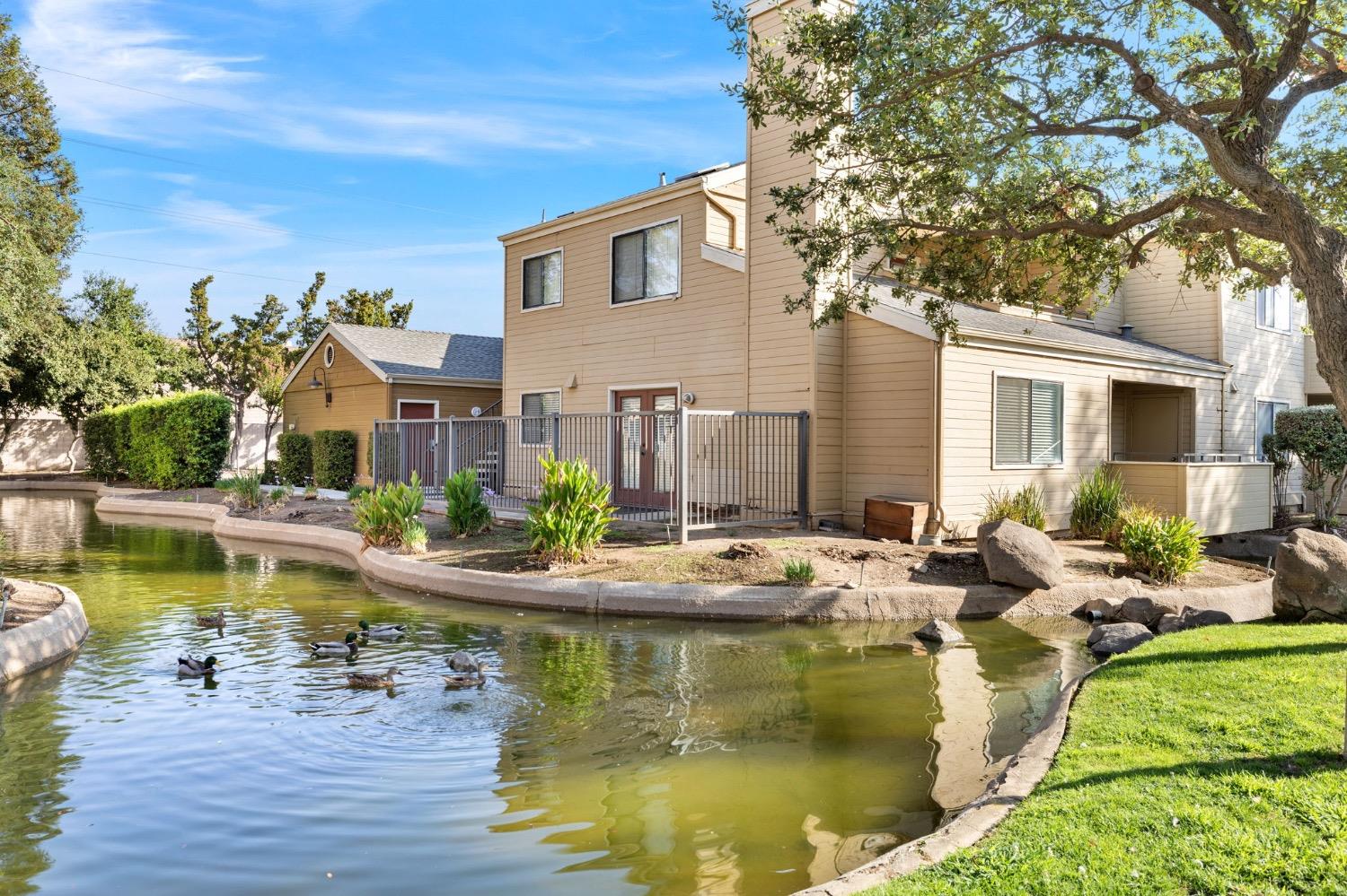 7675 North First Street, Unit 136 Fresno, CA 93720 - Photo 5 of 42 a view of swimming pool with outdoor seating and plants