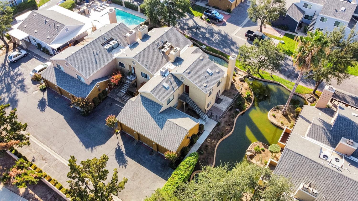 7675 North First Street, Unit 136 Fresno, CA 93720 - Photo 9 of 42 an aerial view of residential house with outdoor space and parking