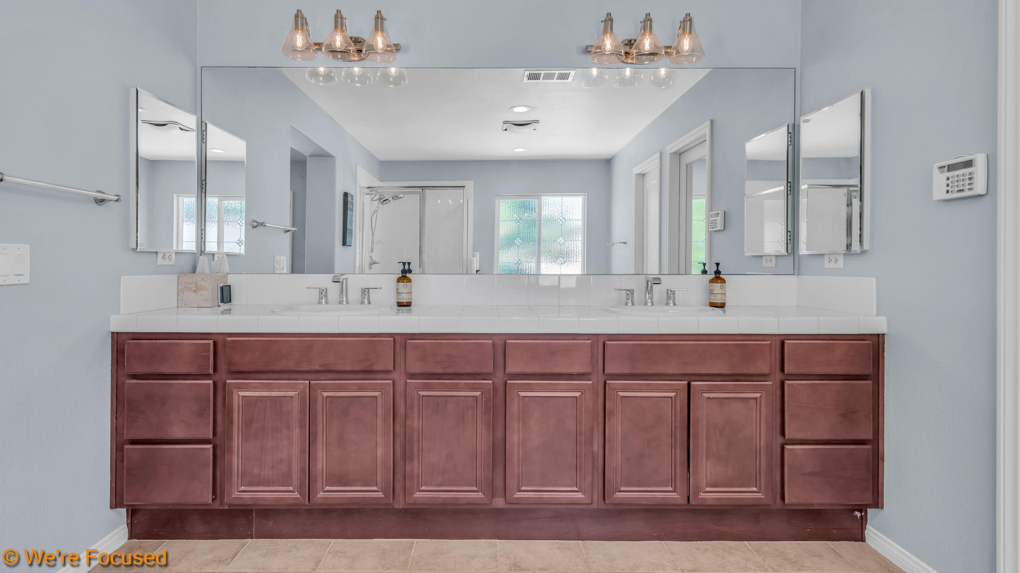 33856 Augusta Circle Yucaipa, CA 92399 - Photo 22 of 55 a bathroom with a sink vanity and mirror