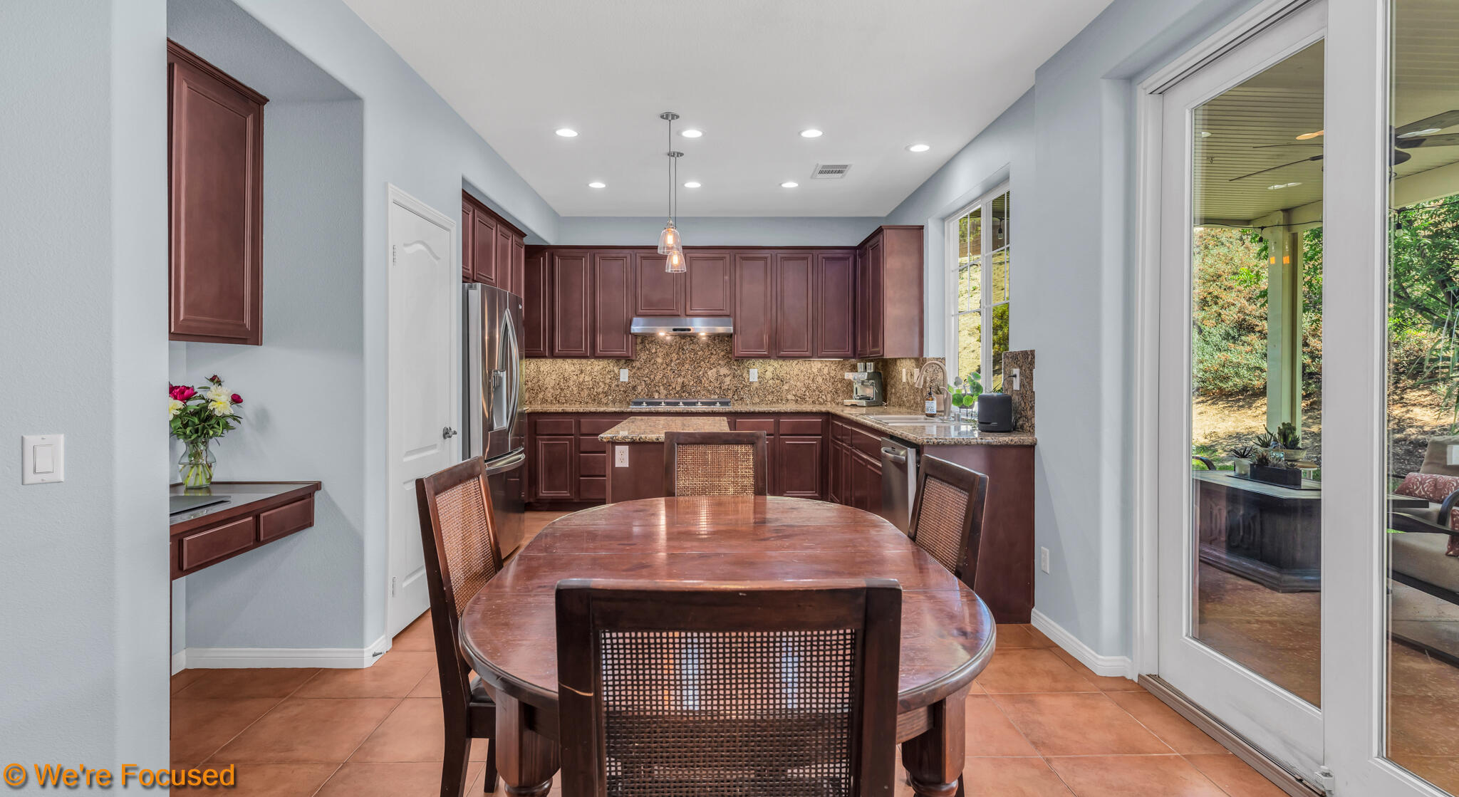 33856 Augusta Circle Yucaipa, CA 92399 - Photo 7 of 55 a kitchen with a dining table chairs and refrigerator