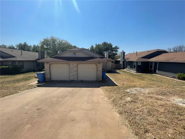 a view of a house with a yard and sitting area