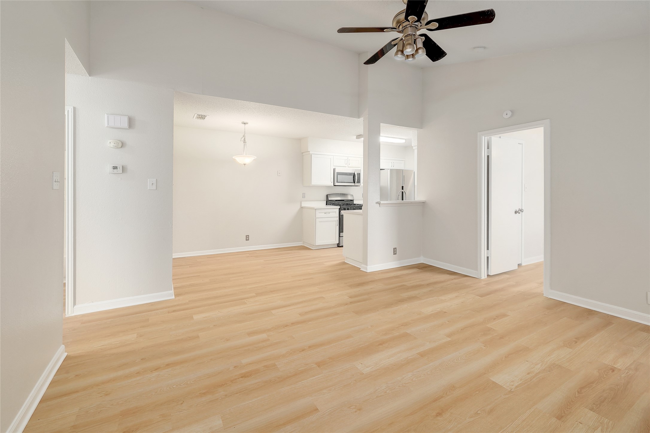 1915 Margalene Way Austin, TX 78728 - Photo 11 of 23 a view of empty room with wooden floor and ceiling fan