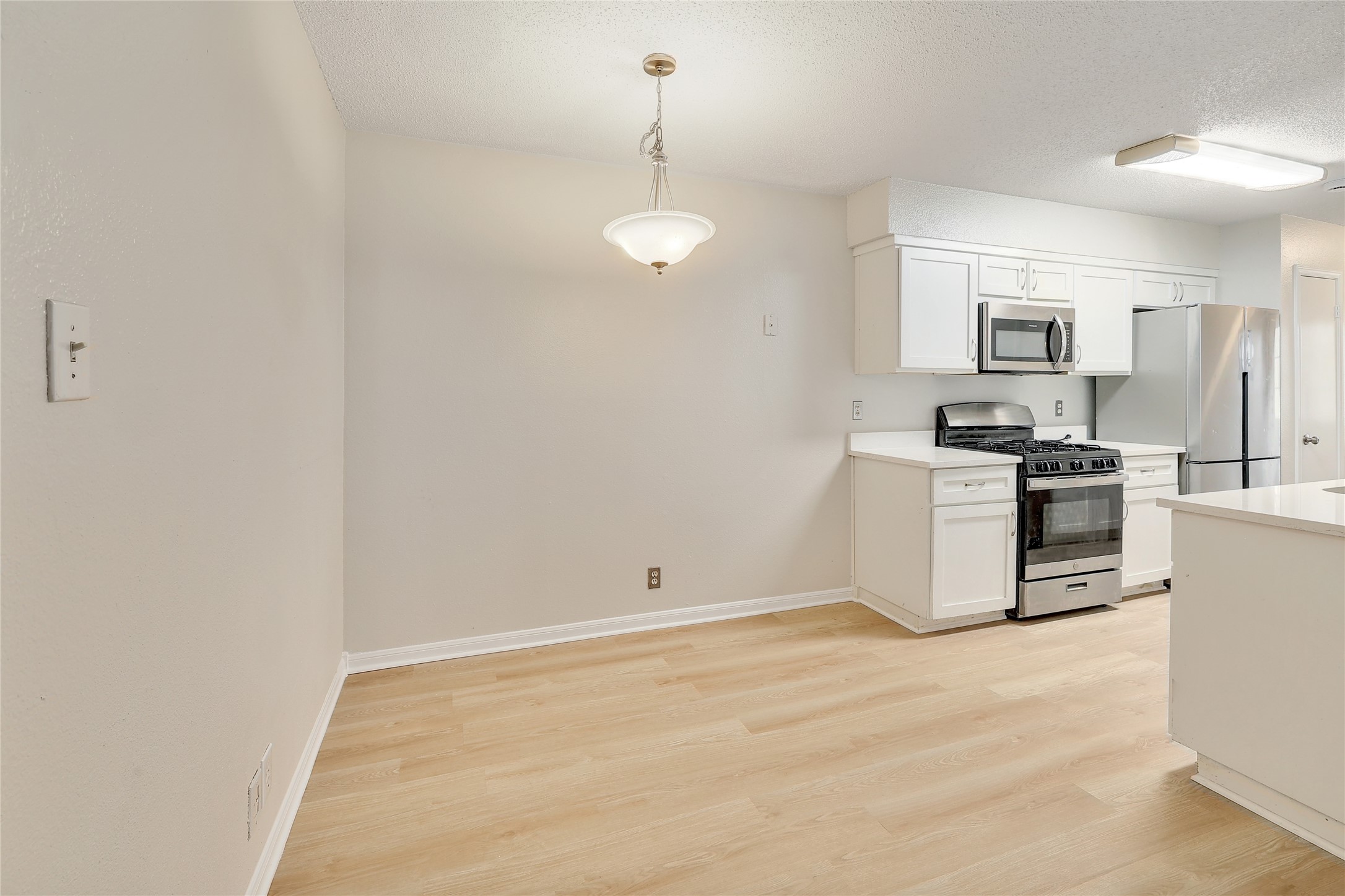 1915 Margalene Way Austin, TX 78728 - Photo 12 of 23 a kitchen with granite countertop a stove a sink and a refrigerator