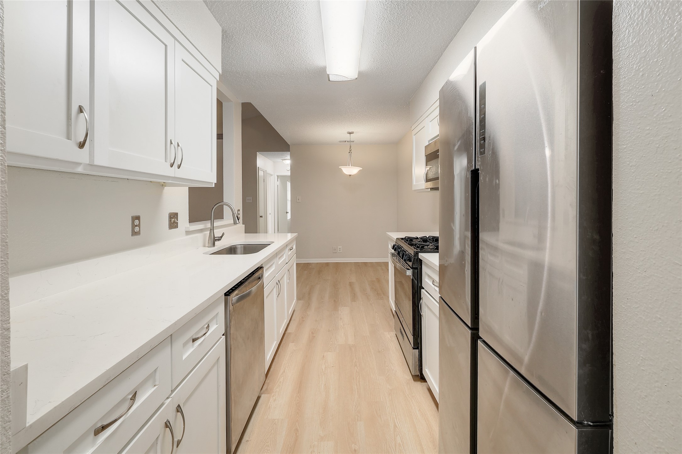 1915 Margalene Way Austin, TX 78728 - Photo 15 of 23 a large white kitchen with stainless steel appliances