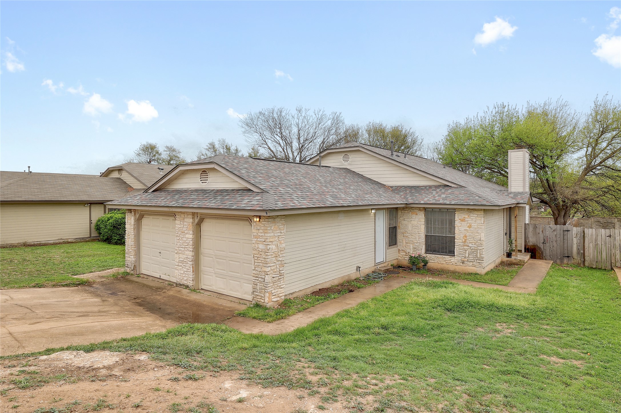 1915 Margalene Way Austin, TX 78728 - Photo 17 of 23 a front view of a house with a yard and a garage