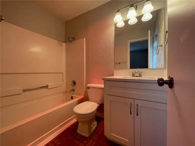a bathroom with a sink a toilet and a mirror