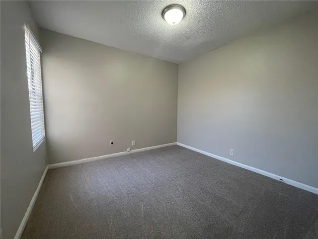 an empty room with a empty space and a window