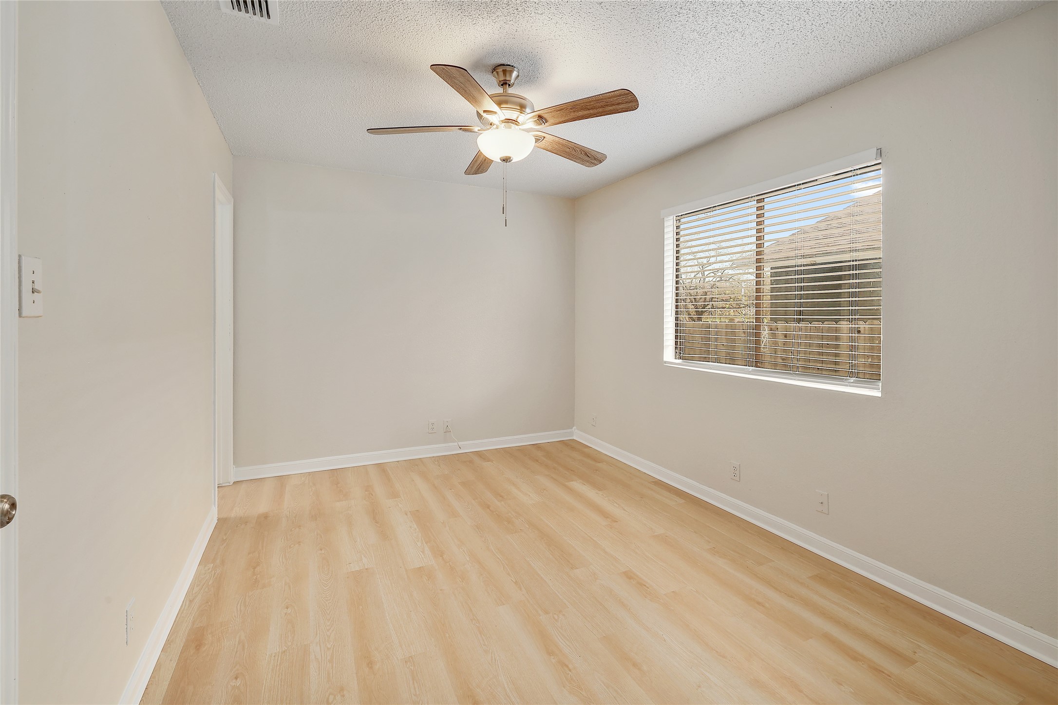 1915 Margalene Way Austin, TX 78728 - Photo 6 of 23 a view of an empty room with wooden floor and a window